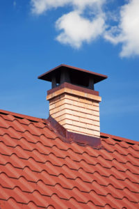 a lovely chimney cap on a red roof