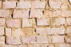 deteriorating brick wall